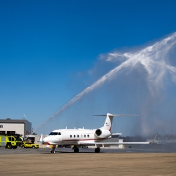 Water shoots over an aircraft.