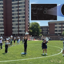 Students hold radar reflectors as they stand on a soccer field. An inset image shows two Ls as seen from space.