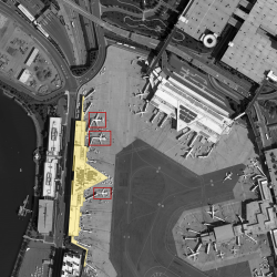 A goal of the program is to develop a system that can identify spatial relationships between objects in a scene, such as counting how many planes are parked at the terminal on the left.