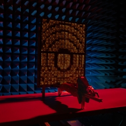 A prototype reflectarray faces a feed horn in an anechoic chamber.