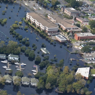 aerial image showing a neighborhood flooded by a natural disaster. 