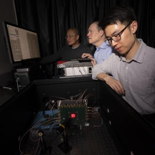 From left to right, Niyom Lue, Jonathan Richardson, and Tom Cheng test the detector in the laboratory.