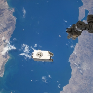 A payload shown above the Gulf of California, just after it was jettisoned by a robotic arm from the International Space Station into orbit. 