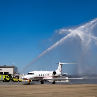 Water shoots over an aircraft.
