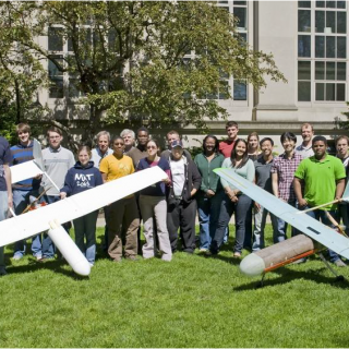Photo of MIT students with UAVs they designed and built
