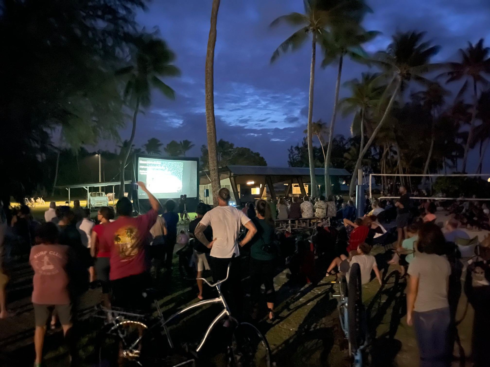 People gather outside at night for an astronomy talk. 