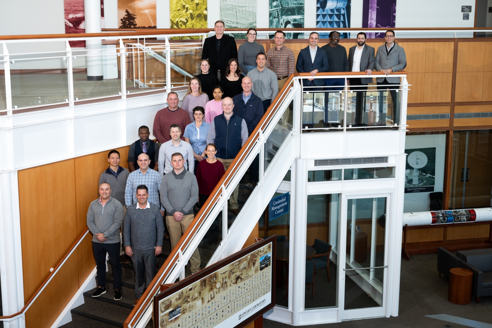A group of 24 people representing Lincoln Laboratory and students and staff of the Air Command and Staff college pose for a group photo. 