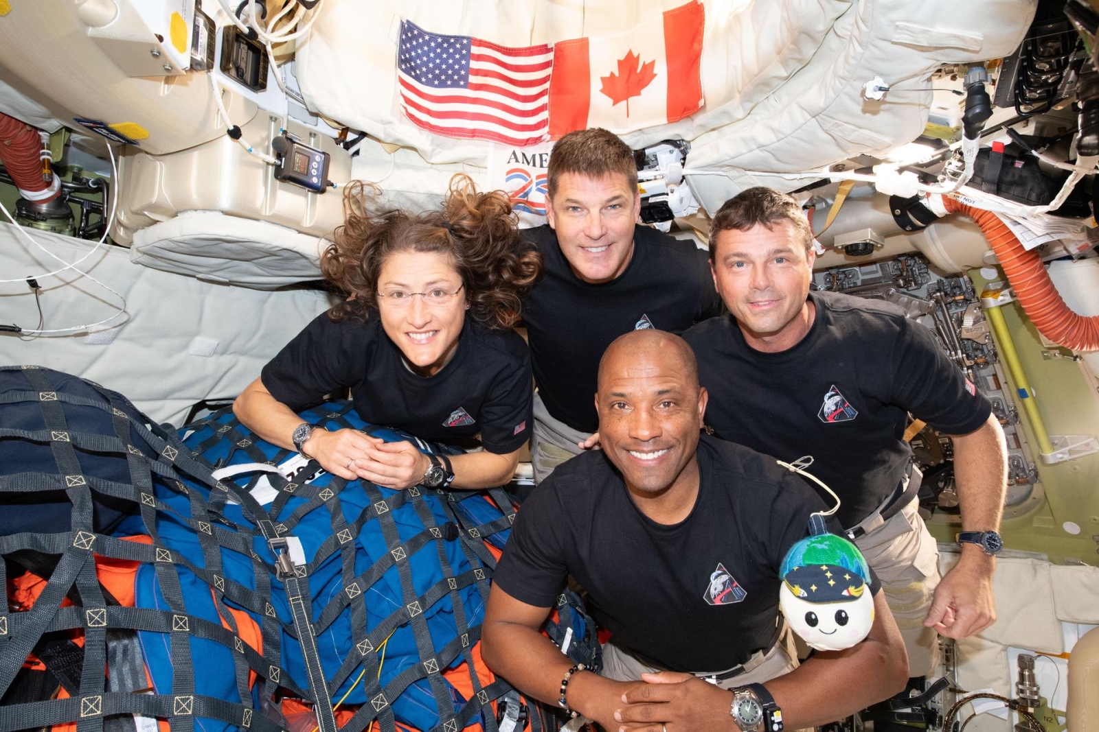 Four astronauts experience zero gravity in space.