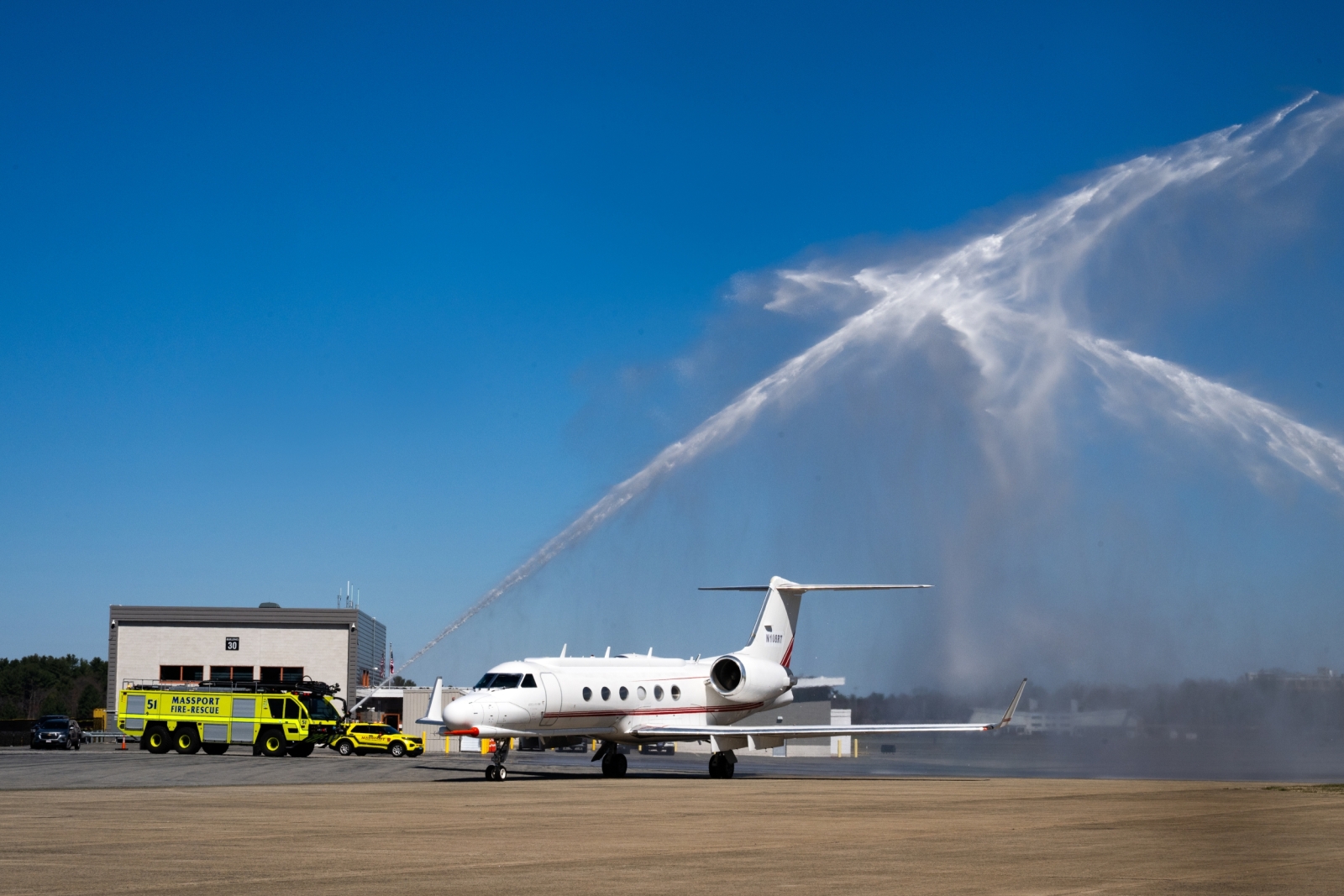 Water shoots over an aircraft.