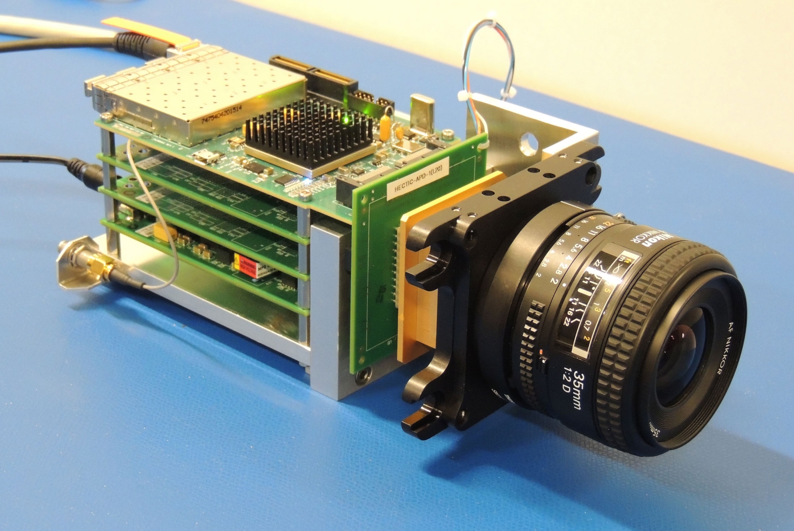 Photo of the lens and electronics of the Dual-Mode Imaging Receiver (only 2 of the 4 boards in the chassis are populated, the other 2 are available for additional functions).