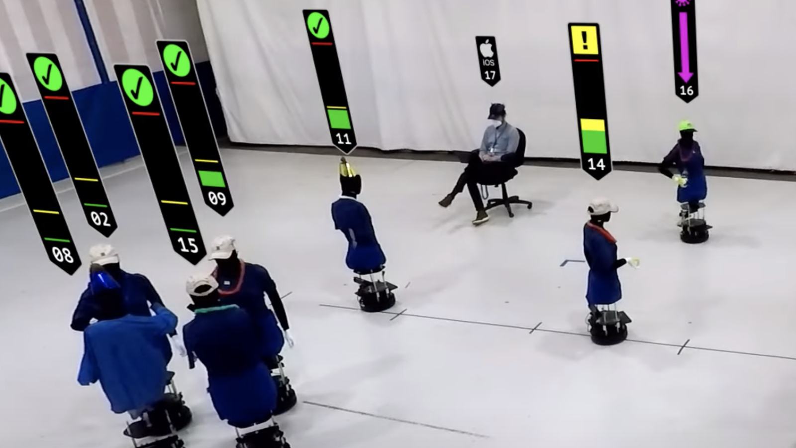 An screengrab from the video showing about a dozen robots in a large room (representing humans at a party)