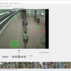 A snapshot of a software interface shows a video feed of a subway station, with green box around a man walking, and green arrows showing possible routes. At the bottom of hte interface is more, smaller screenshots of people in the video. 