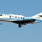 an airplane flying against a blue sky background