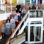 A group of 24 people representing Lincoln Laboratory and students and staff of the Air Command and Staff college pose for a group photo. 