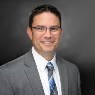 Formal portrait of Derek Jones.