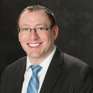 A portrait photograph of Adam Schnabel.
