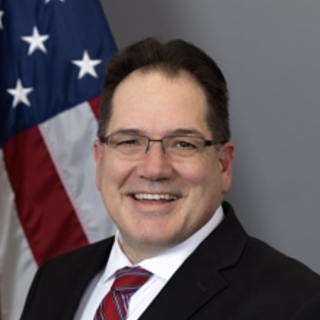 Terry Carpenter formal portrait in front of an american flag
