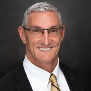 A portrait photograph of Gregg Shoults.